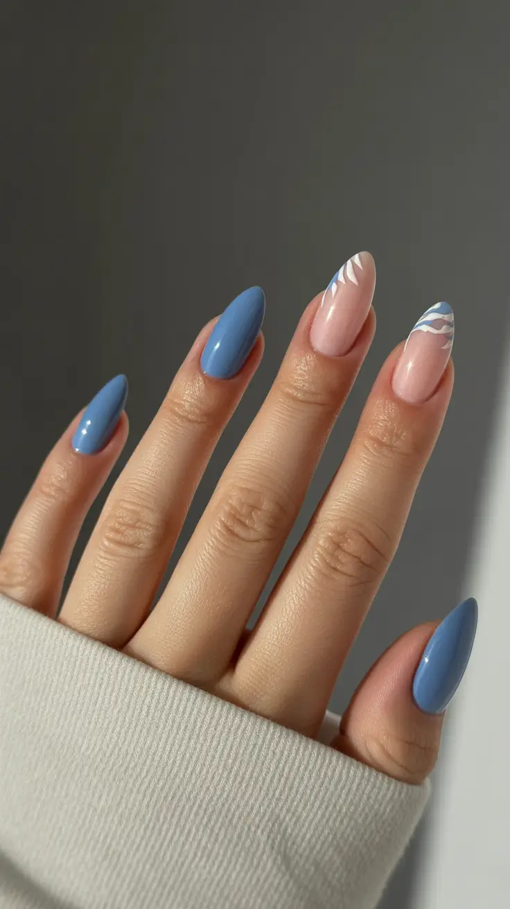 fun spring nails 2026 Soft blue almond with delicate white leaf accents