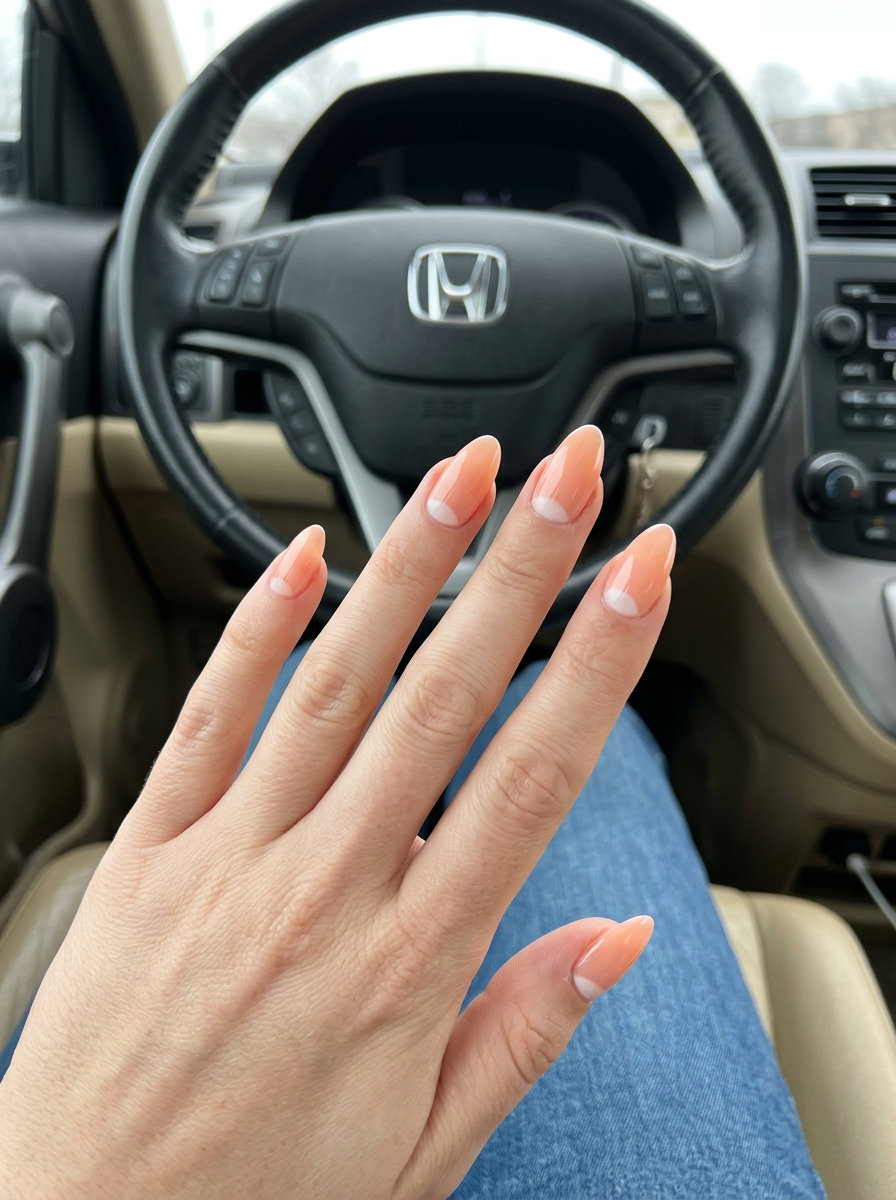 Almond summer nails 2026 for fair skin: Soft peach reverse French with milky white crescent. Office & brunch ready.