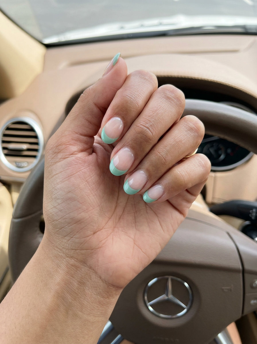 Chic short round summer nails 2026: Seafoam green negative space French tip for elegant events.