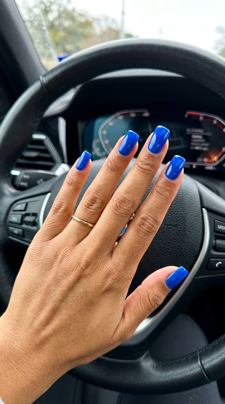 Bold electric blue coffin nails for parties and nights out. Solid summer nails 2026.