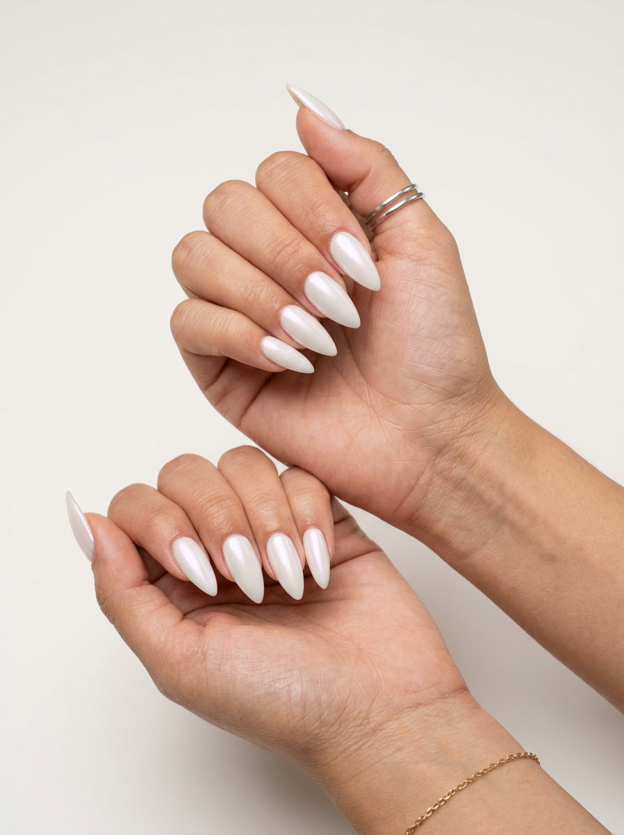 Ethereal Pearl Stiletto nails: opaque soft white gel with pearlescent shimmer for weddings 2026.