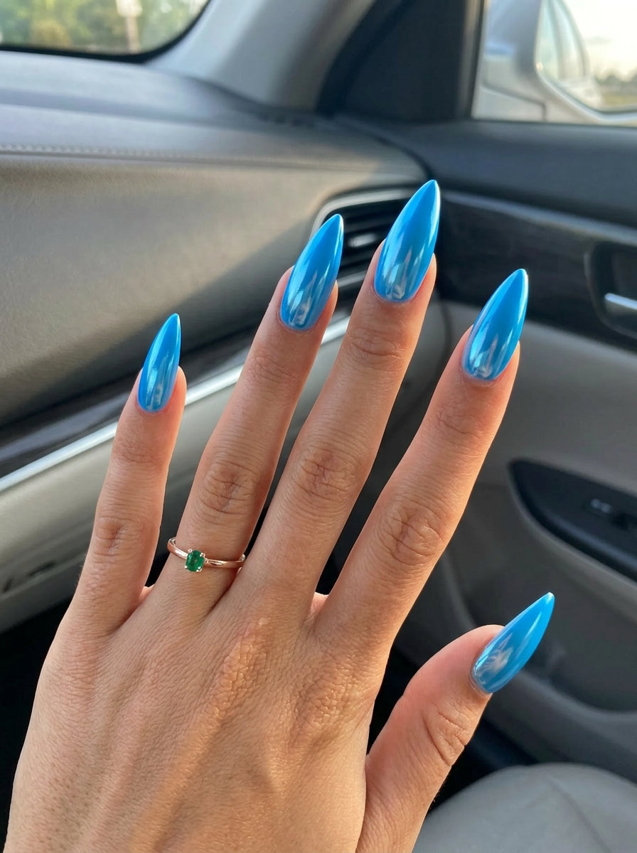 Electric sky blue chrome stiletto nails for summer nail inspo 2026. Futuristic mirror finish for a bold look.