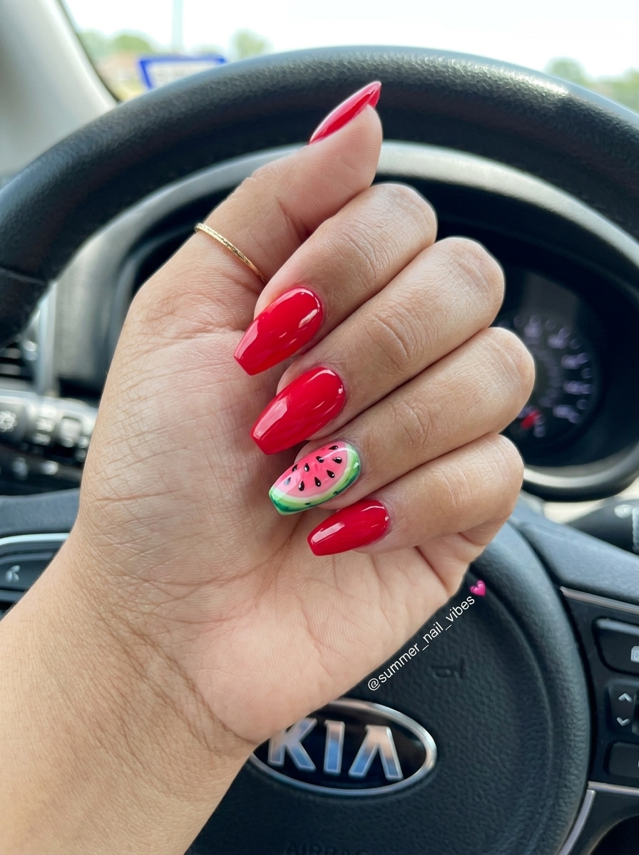 Watermelon slice accent stiletto nails for summer nail inspo 2026. Vibrant red with green gradient and black seeds.
