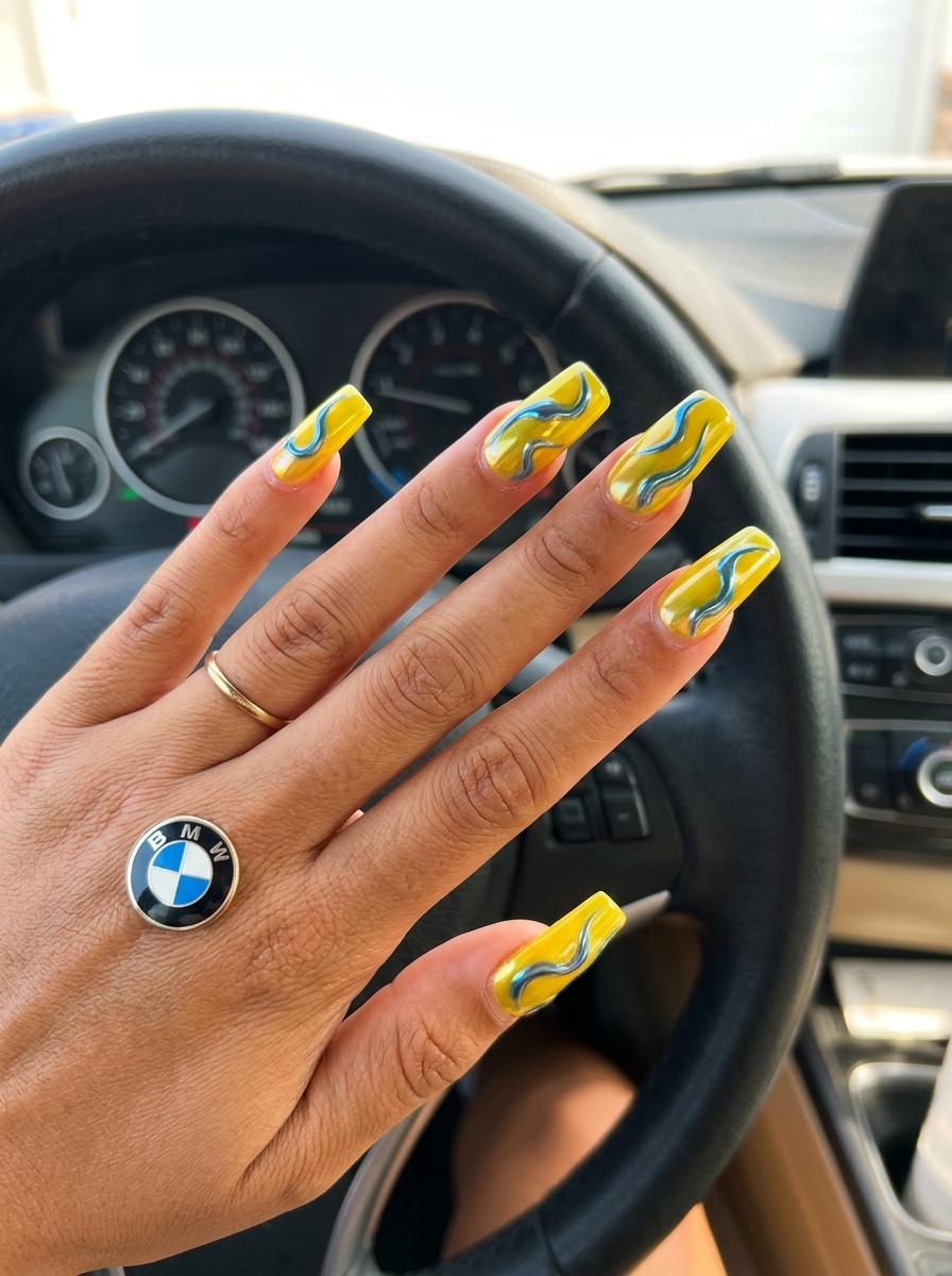 Goldenrod metallic swirls stiletto summer nails 2026 for edgy party and festival looks. Glamorous artistic style.