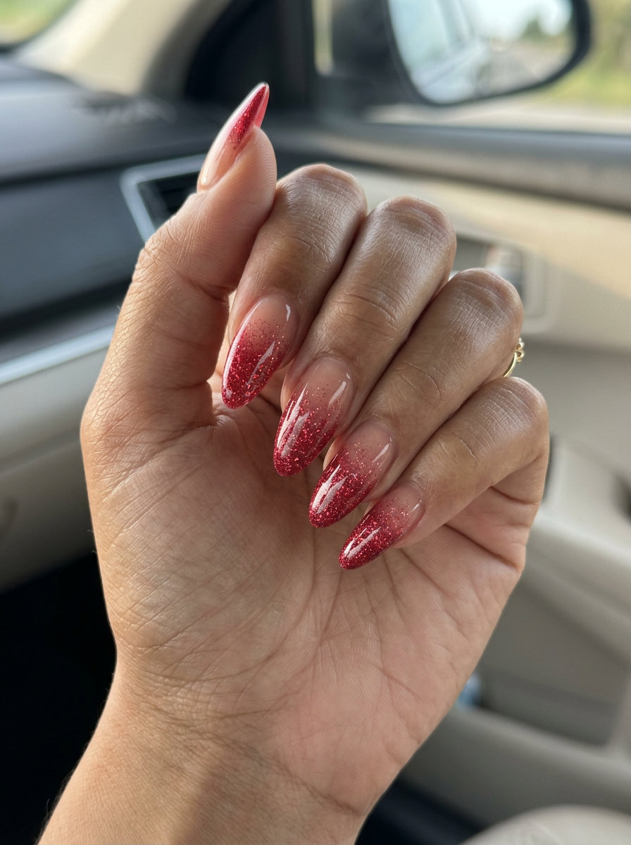 Trending summer nails 2026: Sparkling cherry red glitter gradient on almond nails for celebrations.