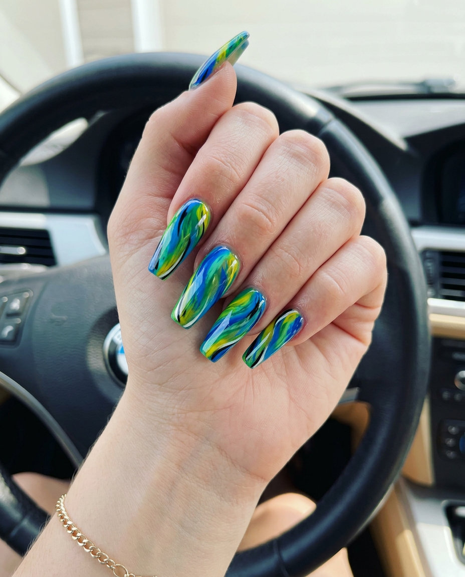 Exotic Bird Feather coffin nails 2026: Electric blue, emerald green, yellow abstract swirls for festivals.